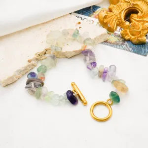 Closeup of colorful natural gemstone chip bracelet with gold plated OT clasp detail.