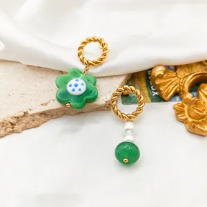 Asymmetric glass flower stainless steel earrings with pearls and green beads, chic style.