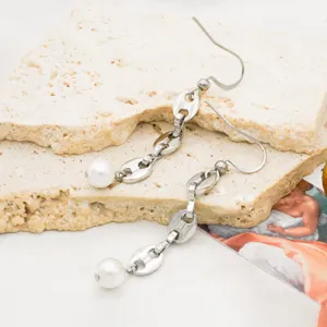 Detailed view of stainless steel pig nose chain link dangle earrings with white pearl pendants.