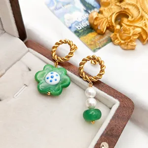 Exquisite asymmetric glass flower and pearl drop earrings with stainless steel twisted hoops.