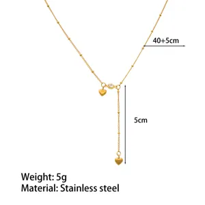 Stainless steel gold lariat necklace featuring double heart charms and shimmering cubic zirconia.