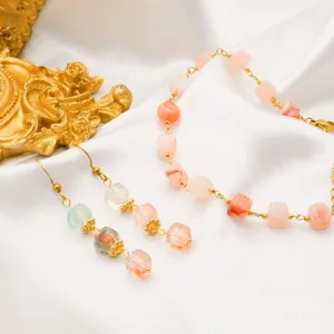 Detail view of minimalist pink resin cube bead earrings and bracelet with 18k gold plated chain.
