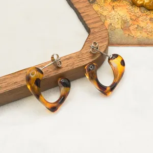 Retro leopard print heart-shaped resin stud earrings, chic fashion jewelry accessory detail.