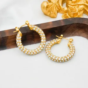 Close-up of elegant 18k gold plated stainless steel paved crystal huggie hoop earrings detail.