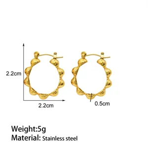 Detailed close-up view of gold stainless steel beaded hoop earrings with texture design.