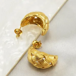 Detailed shot of gold-plated woven dome hoop earrings, showcasing intricate textured design.