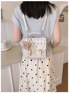 Cute sweet bow print mini backpack detail view, stylish casual travel daypack for women and girls.
