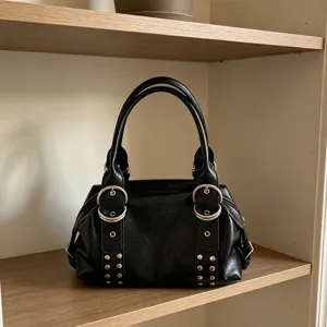 Vintage black PU leather Boston handbag for women, chic metal ring and stud shoulder bag.