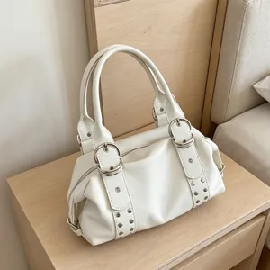 Retro white PU leather Boston handbag detail, featuring metallic rings and chic studs.