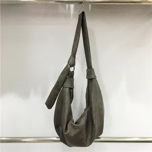 Detail view of the retro soft leather hobo shoulder dumpling bag with stylish slouchy pleats.