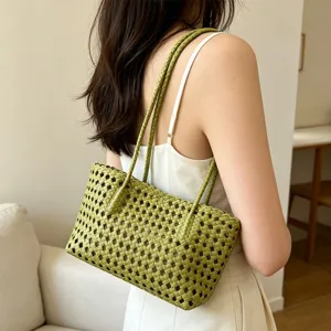 Green woven hollow shoulder bag detail view, stylish summer beach handbag for women.