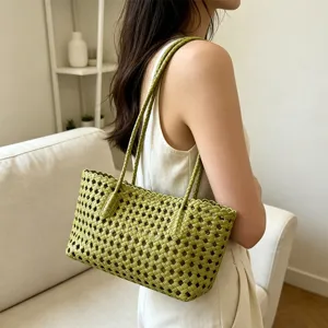 Green woven leather shoulder bag detail shot, ideal for summer beach and vacation daily wear.