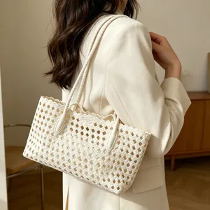 Close-up detail of the woven hollow shoulder bag texture, ideal for summer beach resort styling.