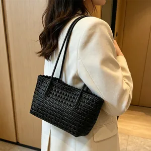 Black woven shoulder bag detail, elegant summer beach tote bag, casual daily handbag.