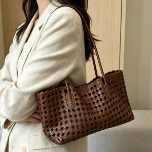 Brown woven leather shoulder bag detail, stylish hollow out design with scalloped trim.