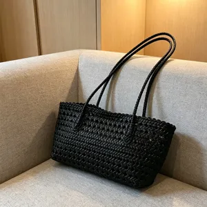 Black woven beach bag detail view, hollow out summer straw tote, casual shoulder handbag.