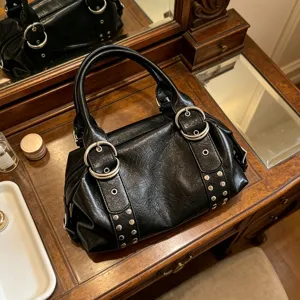 Retro black PU leather Boston handbag for women, chic metal ring and stud underarm shoulder bag.