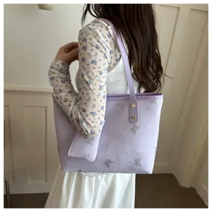 Detail shot of the light purple tote bag with silver glitter butterfly print and pouch.