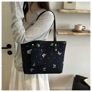 Detail view of butterfly print tote bag with sparkle details and mini pouch for women.