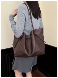 Vintage dark brown tote bag detail showing large capacity and stylish knotted strap.