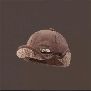 Vue rapprochée de la casquette aviateur en velours côtelé marron avec doublure en mouton.