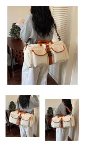 Grande borsa da viaggio in tela con tasche multiple e bordo arancione per lo sport.