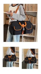 Primo piano dettagliato del borsone nero con cinturini arancioni vivaci e tasche.
