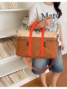 Color block travel duffel bag large capacity canvas gym shoulder bag close-up view.