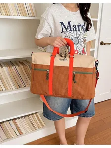 Color-block travel duffel bag with large capacity, orange straps and casual style for daily use.