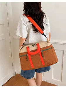 Patchwork travel duffel bag detail, showing spacious capacity and vibrant color contrast style.