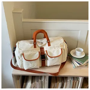 Vista dettagliata della borsa da viaggio casual in tela con dettagli arancioni sullo scaffale.
