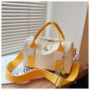 Segeltuch Reisetasche mit gelben Griffen und Schultergurt fuer Outdoor und Alltag.