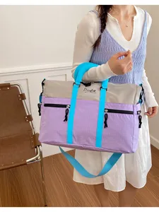 Detailed view of the color block travel bag, showing spacious design and durable material.