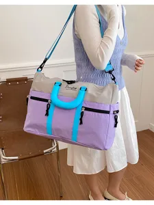 Dopamine colorblock travel bag detail, large capacity shoulder luggage with contrast handles.