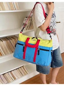 Colorblocked travel duffel bag with large capacity and durable fabric for daily fitness and trips.