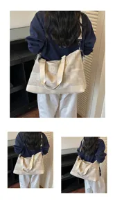 Large capacity canvas travel bag for women, portable lightweight luggage bag, beige.