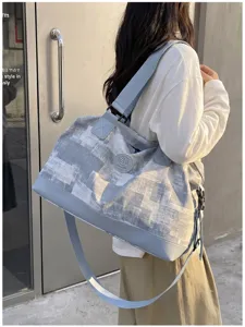 Large capacity travel duffel bag for women, casual shoulder weekender bag with strap.