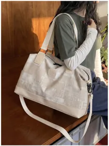 Close-up of canvas travel duffel bag shoulder carry style lifestyle shot elegant accessory