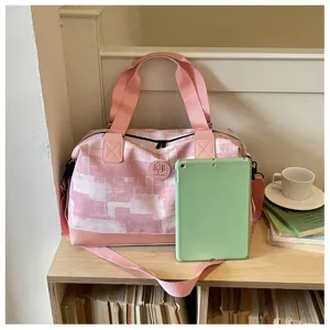 Pink travel duffel bag detail view, showing spacious capacity and daily organization for trips.