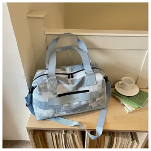 Lightweight travel duffel bag for women, large capacity canvas weekender bag with strap.