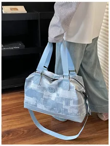 Lightweight travel duffel bag with large capacity, dual handles and adjustable shoulder strap.