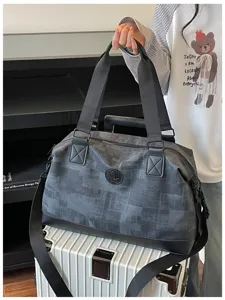 Large capacity travel duffel bag for women, portable waterproof overnight weekender bag with handles.