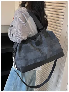 Large capacity travel duffel bag in dark grey geometric pattern with black bottom and shoulder strap.