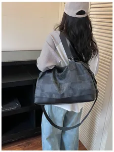 Large capacity travel duffel bag for women, lightweight waterproof weekender luggage bag.