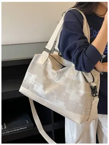 Large capacity canvas travel duffel bag with shoulder strap for women, casual daily use.