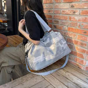 Large capacity travel duffel bag for women, lightweight waterproof weekender luggage bag with strap.