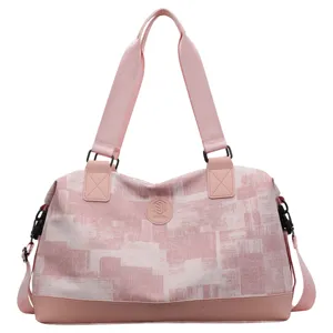 Pink geometric print travel duffel bag with double top handles and shoulder strap main view