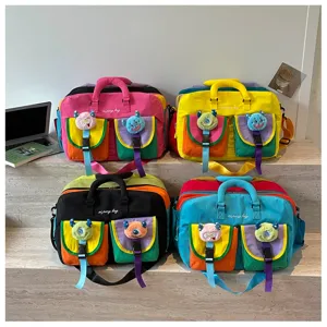 Detail view of colorful travel gym bags with cute plush monster pockets and spacious design.