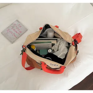 Large capacity color-block travel duffel bag for women, stylish sports fitness shoulder bag.