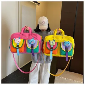 Large capacity colorblock travel fitness bag with cute monster plush charms for women.